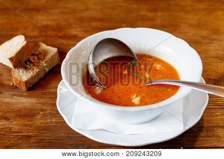 Bouillabaisse in Copper Pot on a wooden background