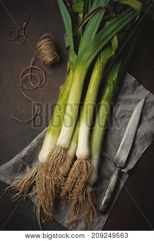 Group of fresh onion pareying on a dark concrete background. Selective focus.Top view. Copy space.