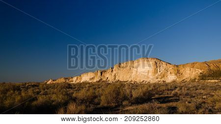 Panorama view to Plateau Ustyurt from the edge of Aral sea near Aktumsuk cape at sunrise in Karakalpakstan Uzbekistan