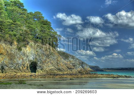HDR image - entrance to a sea grotto at low tide Morgat Crozon peninsula Finistere Brittany France