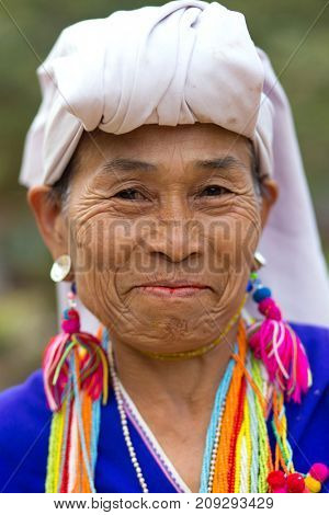 MAE KLANG LUANG, THAILAND - FEBRUARY 18, 2017 : A local Karen hilltribe woman is looking at the camera and smiling in the Mae Klang Luang village near Chiang Mai, Thailand