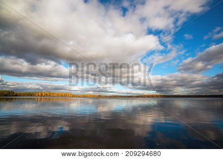 White clouds over the lake in the fall.