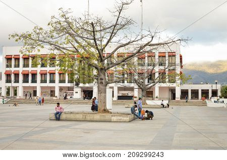 Tuxtla Gutierrez Mexico - January 15 2015: People stroll the huge main square of the modern city of Tuxtla Gutierrez the capital of Chiapas State. Tuxtla City hall is seen in the background