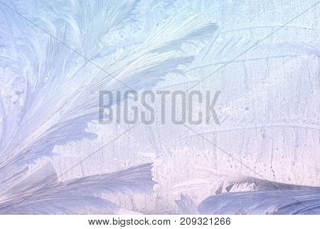 Ice patterns on winter glass. Christmas frozen background. Winter toning effect