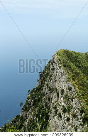 Looking at a cliff on the island of Capri with the ocean fading into the sky.