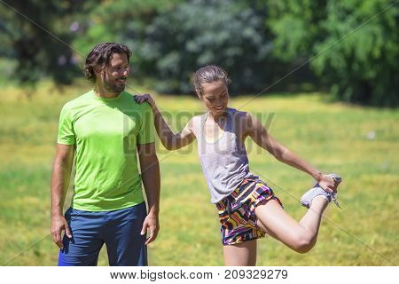 Smiling Couple Stretching Outdoors