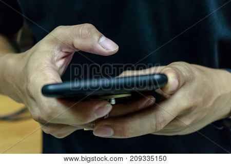 Close up of a man using mobile smart phone
