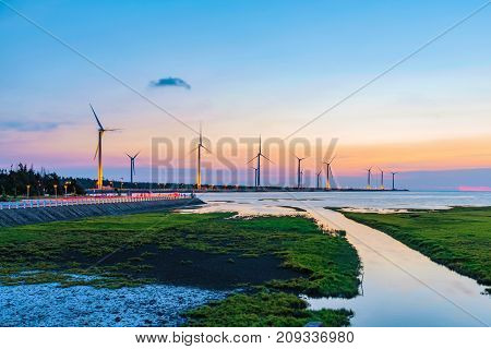 Scenic evening view of wind farm in Gaomei wetlands