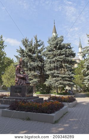 Evpatoria, Republic of Crimea, Russia - July 19, 2017: Monument to the songwriter Ashik Omer in the park near the Juma-Jami mosque in the city of Evpatoria