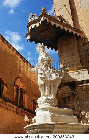 Statue of Virgin Mary with Jesus child on the corner of Carmelite Priory in Mdina. Malta .