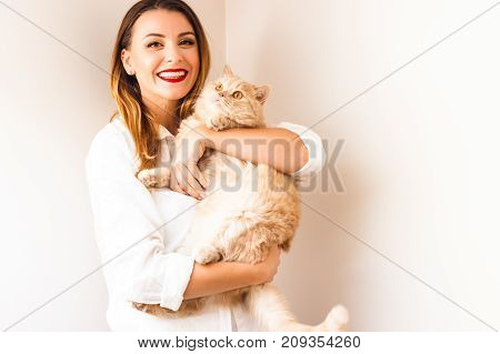 Beautiful girl with a red fluffy cat