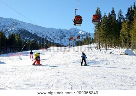 JASNA SLOVAKIA - JANUARY 22: The snowpark skiers and cableway in Jasna Low Tatras. It is the largest ski resort in Slovakia with 49 km of pistes on January 22 2017 in Jasna Slovakia