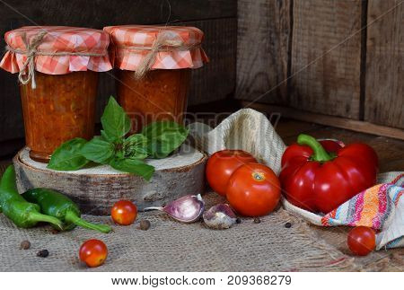 Jars Of Tomato Sauce With Chili, Pepper And Garlic. Bolognese Sauce, Lecho Or Adjika. Preservation.