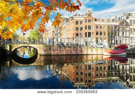 Houses over canal with mirror reflections, Amstardam, Netherlands at autumn day