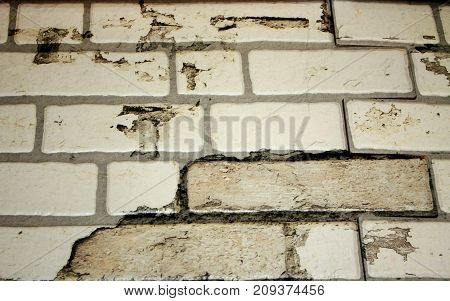 Brick wall of white brick with brown spots. background