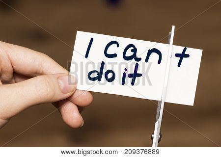 Man Using Scissors To Remove The Word Can't To Read I Can Do It Concept For Self Belief, Positive At