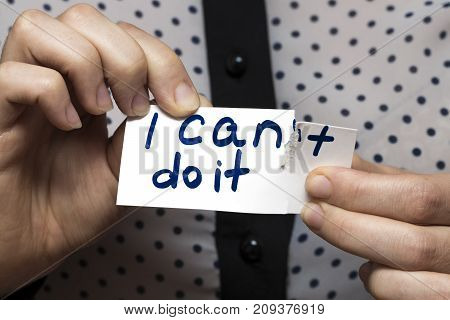 Man Using Scissors To Remove The Word Can't To Read I Can Do It Concept For Self Belief, Positive At