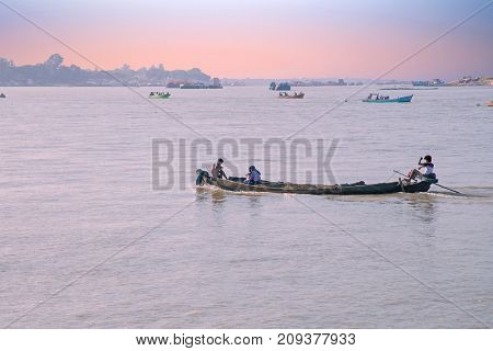  Boats on the Irrawaddy River at sunrise. The Irrawady river is a river that flows from north to south through Myanmar and is the most important waterway