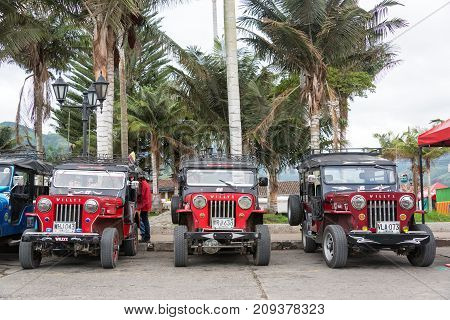 SALENTO COLOMBIA - JUNE 6: Row of red Willys Jeeps in Salento Colombia on June 6 2016