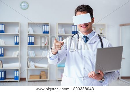 Young doctor with vr virtual reality headset working in the offi