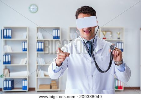 Young doctor with vr virtual reality headset working in the offi