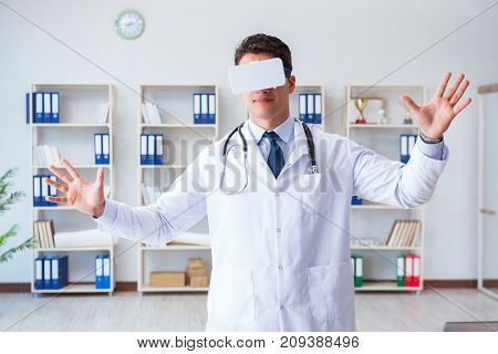 Young doctor with vr virtual reality headset working in the offi