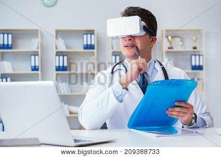 Young doctor with vr virtual reality headset working in the offi