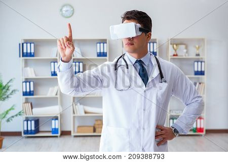 Young doctor with vr virtual reality headset working in the offi
