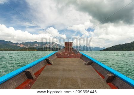 The Nose Of A Long-tailed Boat Against The Background Of The Karst Rocks Of Lake Cheo Lan