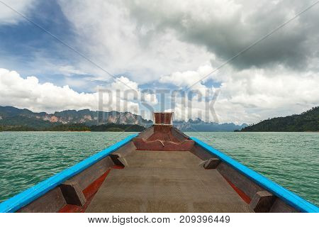 The Nose Of A Long-tailed Boat Against The Background Of The Karst Rocks Of Lake Cheo Lan
