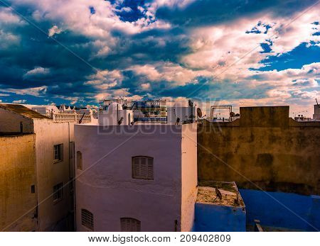 Hammamet, Tunisia. Image of architecture of old medina with dramatic sky at sunset time.