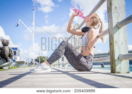 outdoor portrait of young attractive healthy girl doing sport exercise on urban background, sport and healthy lifestyle in the city