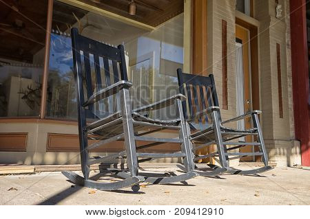 January 9 2016 Goliad Texas USA: rocking chair in the shade of awning in front of a store in historic downtown