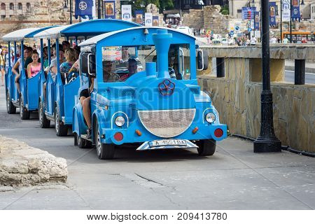 NESEBAR BULGARIA - AUGUST 21 2017: Stylized for the locomotive with the carriages a walking road train. Nesebar is an ancient city and one of the major seaside resorts on the Bulgarian Black Sea Coast.