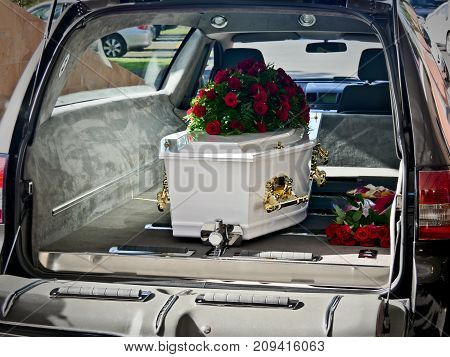 closeup shot of a colorful casket in a hearse or chapel before funeral or burial at cemetery