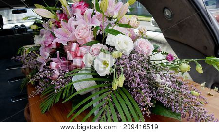 closeup shot of a colorful casket in a hearse or chapel before funeral or burial at cemetery