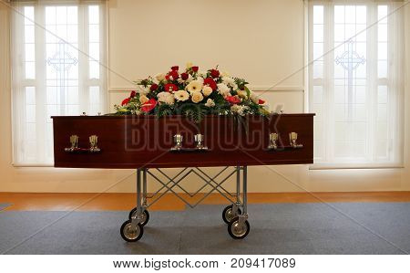 closeup shot of a colorful casket in a hearse or chapel before funeral or burial at cemetery