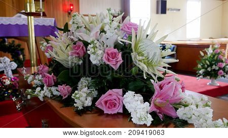 closeup shot of a colorful casket in a hearse or chapel before funeral or burial at cemetery