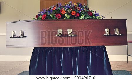 closeup shot of a colorful casket in a hearse or chapel before funeral or burial at cemetery
