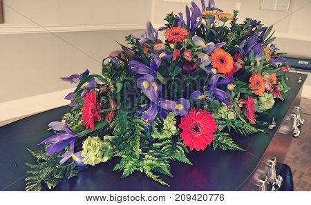 closeup shot of a colorful casket in a hearse or chapel before funeral or burial at cemetery