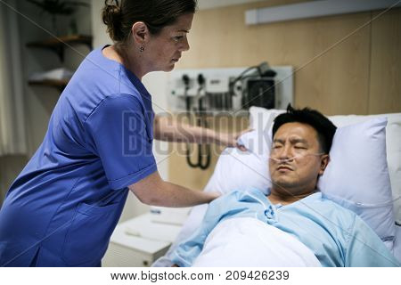 A sick Asian man in a hospital