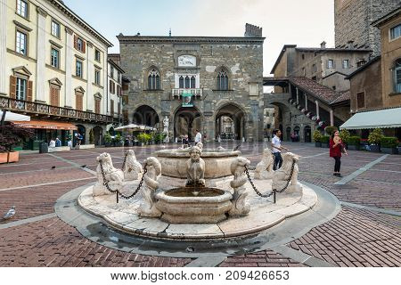 Bergamo Italy - May 27 2016: Contarini Fountain in the main city square Piazza Vecchia of Bergamo old town Italy.