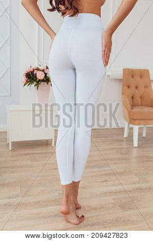 Legs of a sexy girl in white leggings. Mock-up.