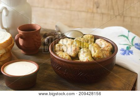 Cabbage rolls served with sour cream bread and wine. Traditional Moldavian or Romanian Sarmale dish traditional Russian or Ukrainian golubtsy. Selective focus.