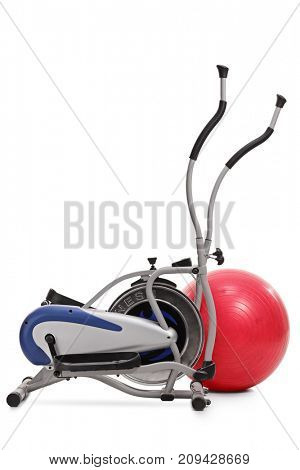 Cross trainer machine and a pilates ball isolated on white background
