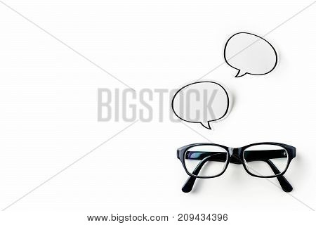 Business concept - Top view of modern office desktop background with blank bubble sticker and smart phone for mockup design and copy space isolated on white background