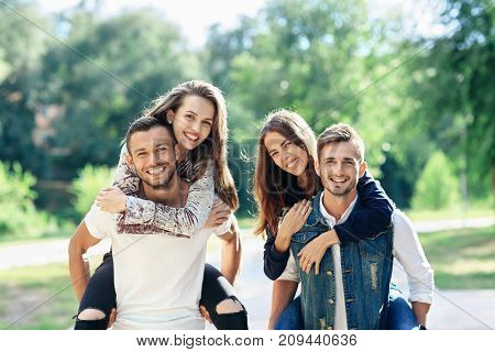 Young Carefree Friends Women And Men In Double Date Outdoors