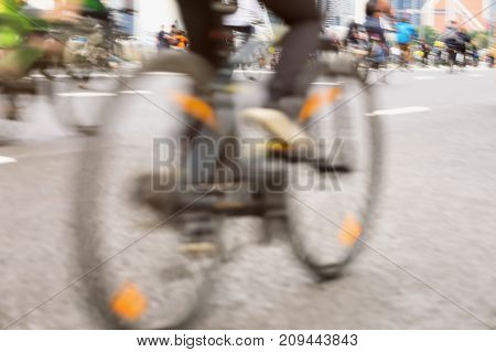 Close-up of cyclists on the bicycle the cyclist's foot on the pedals the marathon on the streets. Sport fitness and healthy lifestyle concept. For modern backdrop