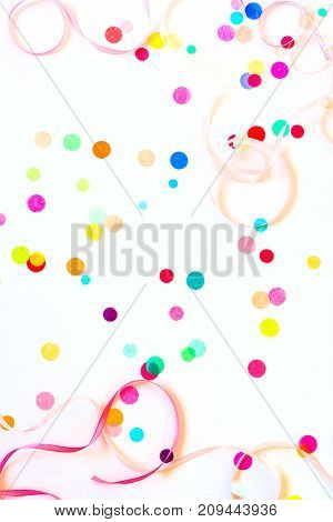 Festive party or carnival confetti on pink background