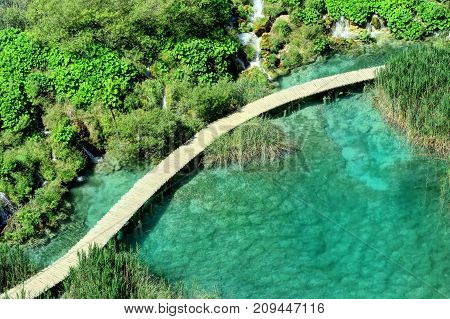 Aerial view Plitvice Lake's famed sapphire water waterfalls and serpentine walkway.